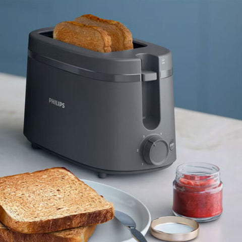 Philips black toaster with toasted bread slices and breakfast setting on a table
